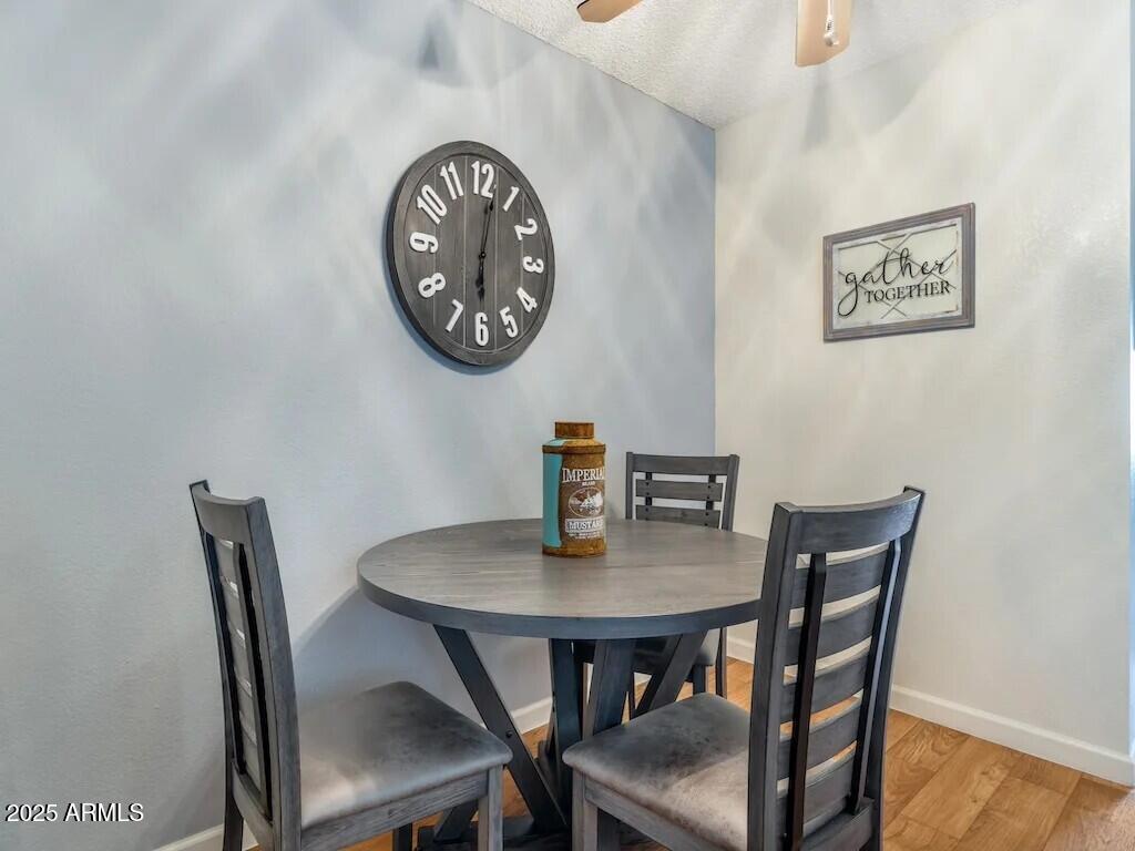 2305 East Main Street, Unit 1 Mesa, AZ 85213 - Photo 4 of 12 a view of a dining room with furniture and wooden floor