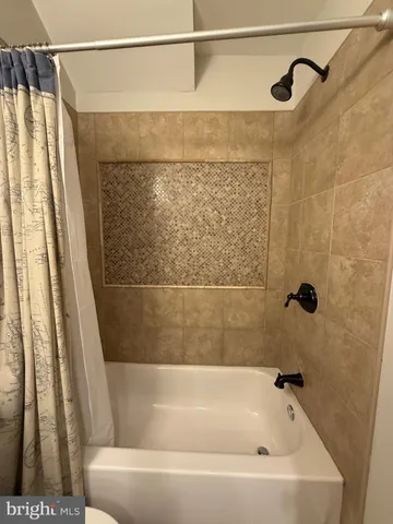 a bathroom with a shower and a bathtub