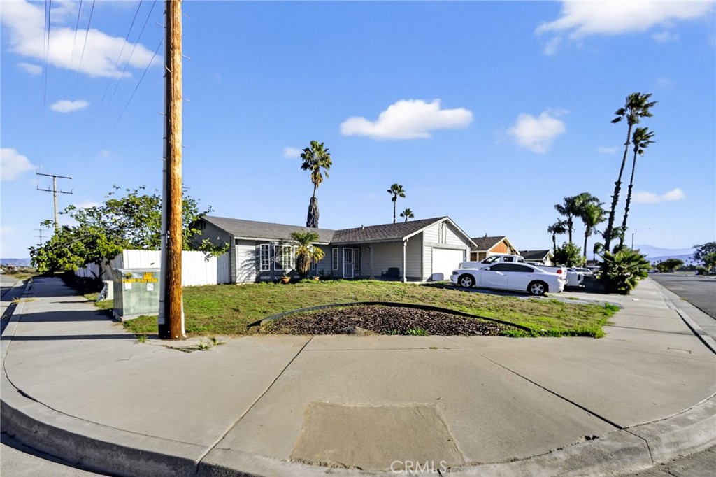 a front view of a house with a yard and a garage