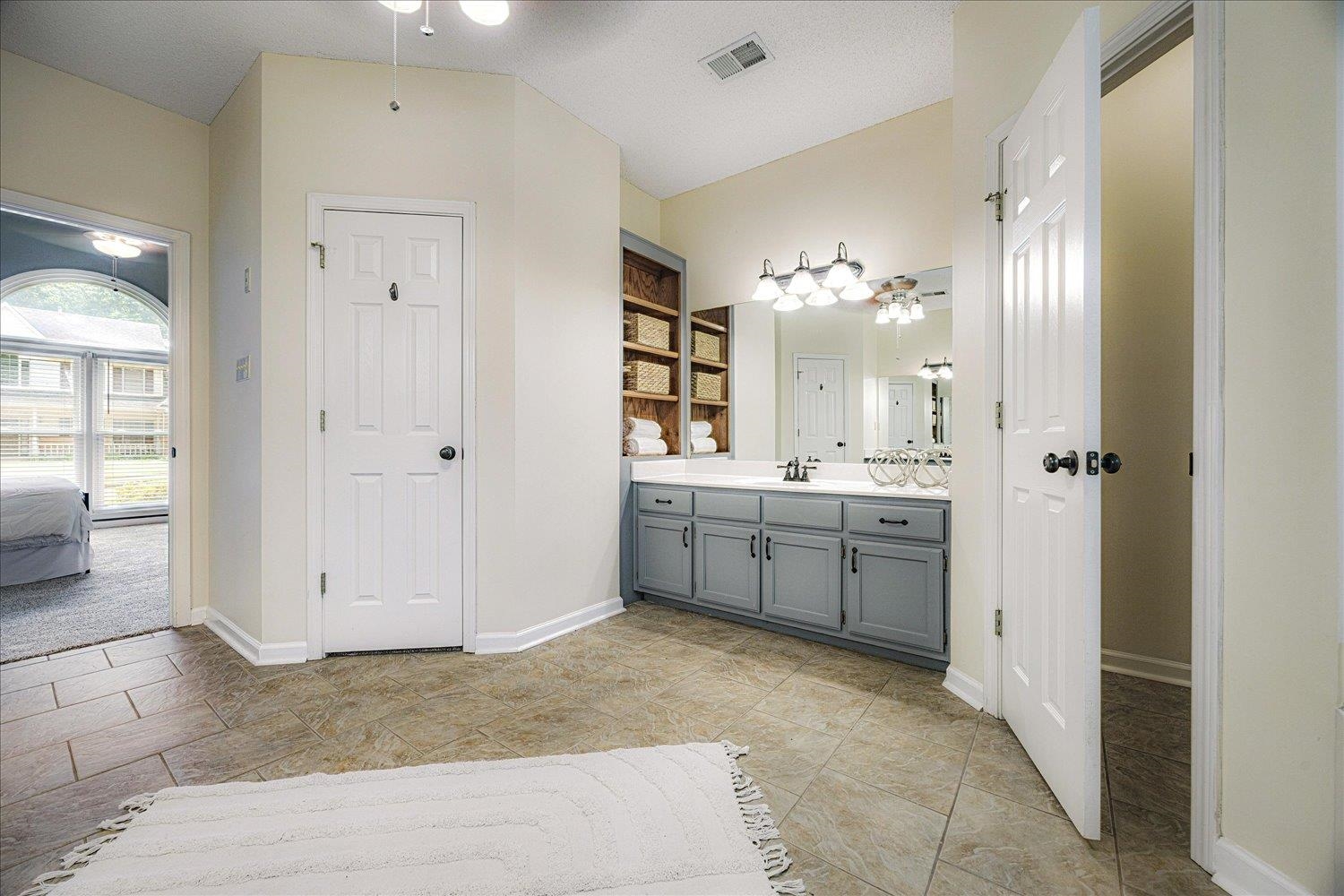 700 Belle Watley Lane Collierville, TN 38017 - Photo 29 of 30 a bathroom with a double vanity sink a toilet and a mirror