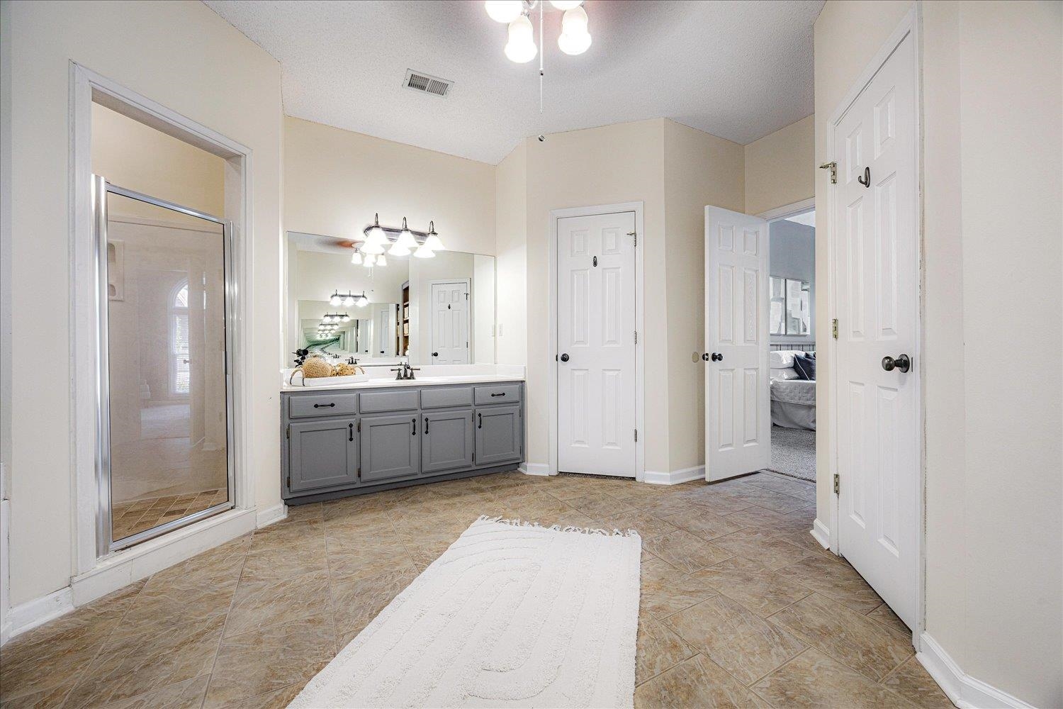 700 Belle Watley Lane Collierville, TN 38017 - Photo 30 of 30 a bathroom with a double vanity sink a mirror a shower and a bathtub
