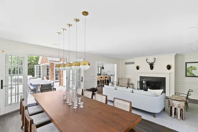 a living room with furniture fireplace and a table