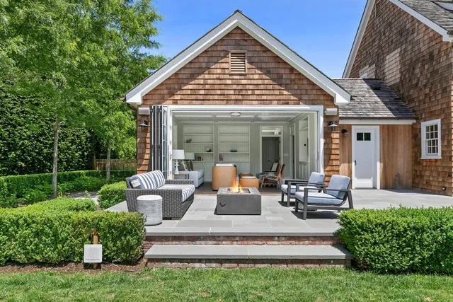 a view of a house with backyard sitting area and garden