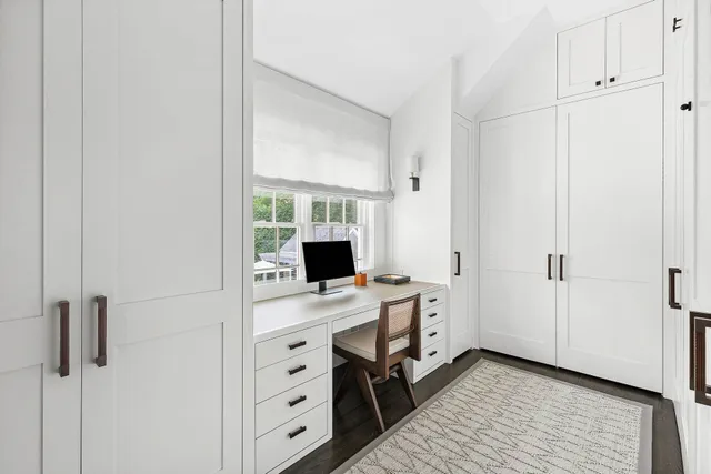 a view of a workspace with furniture and wooden floor