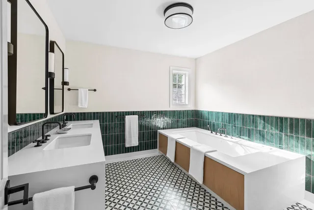 a bathroom with a sink a toilet a mirror and shower