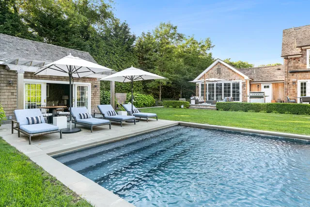 a view of a house with backyard sitting area and garden