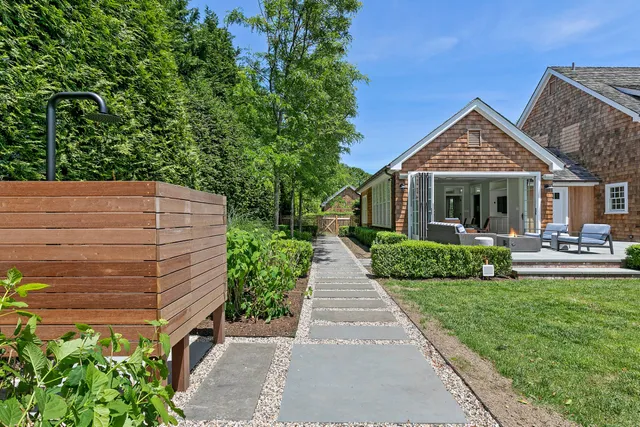 a front view of a house with a garden and plants