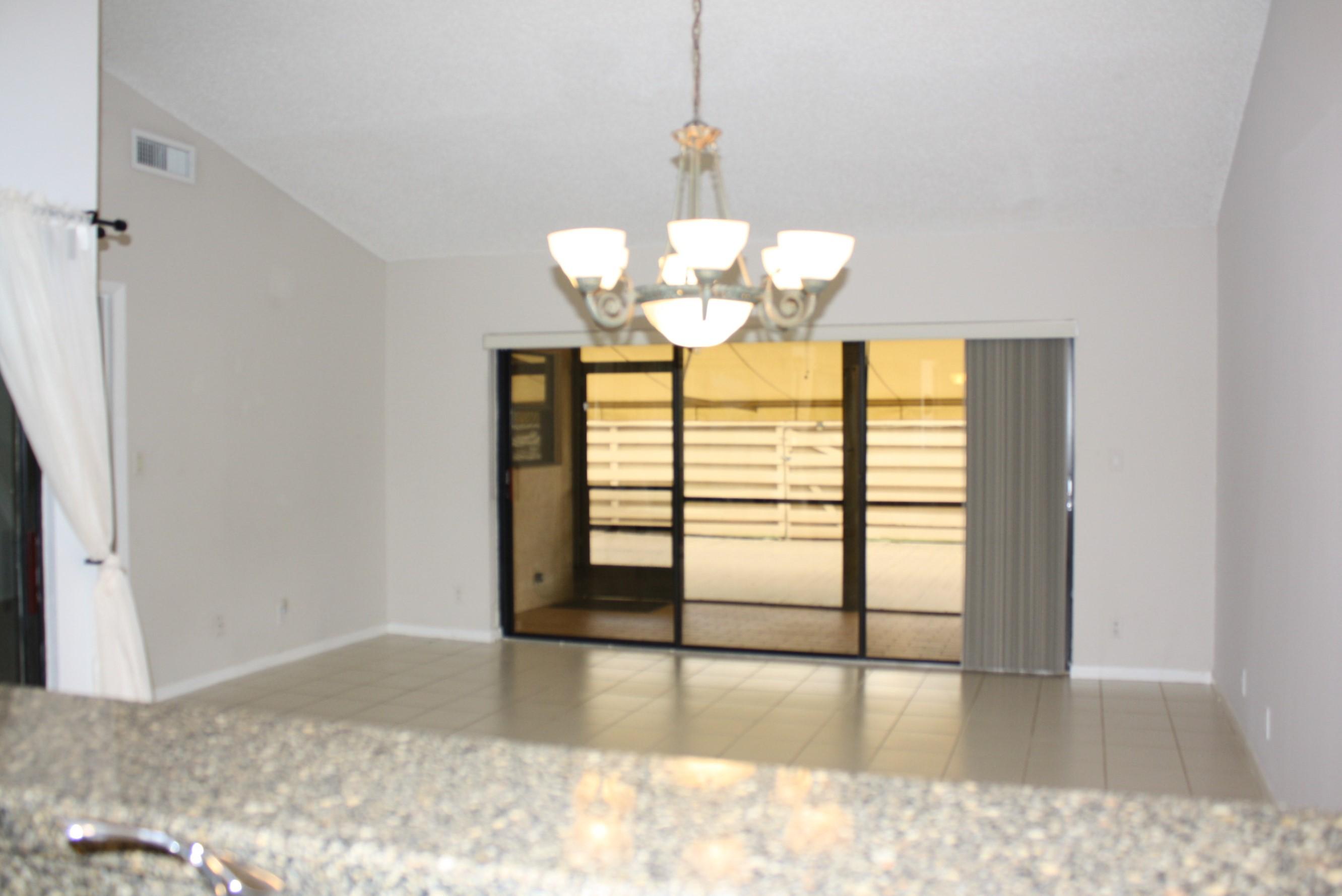 6945 Barbarossa Street Boca Raton, FL 33433 - Photo 9 of 27 LIVING ROOM WITH PATIO AWNING OPEN