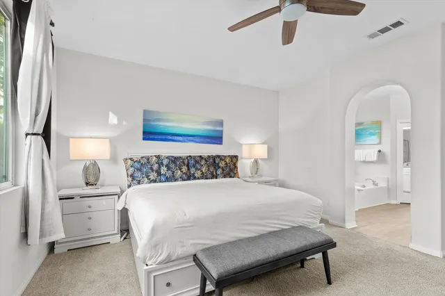 a bedroom with a bed and a painting