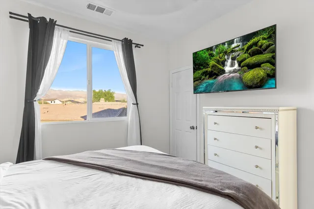 a bedroom with a bed and a window