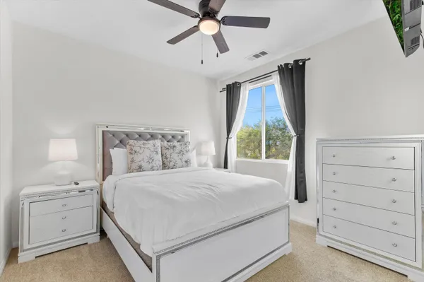 a bedroom with a bed and a window