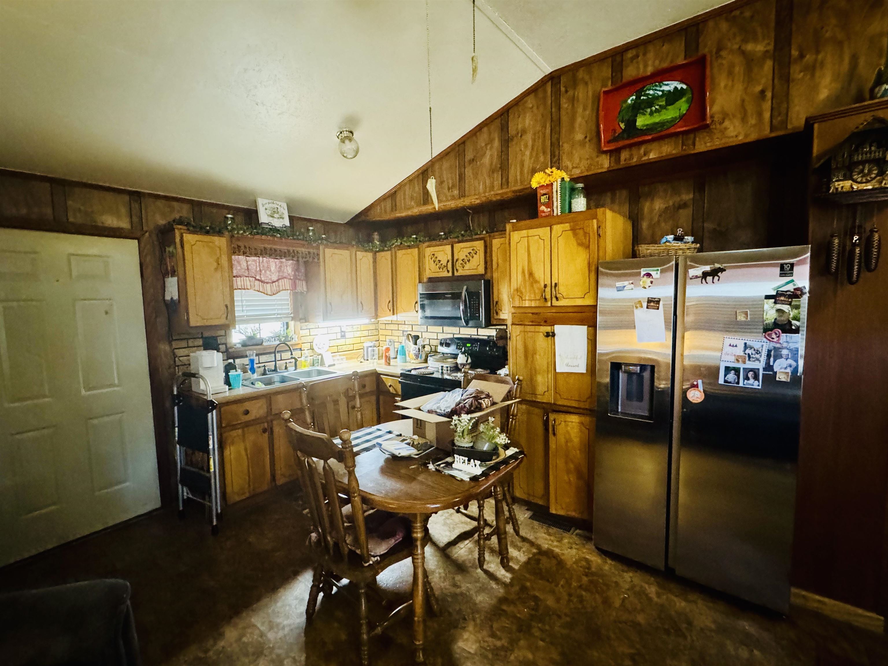 151 Williams Lane Cedar Grove, TN 38321 - Photo 14 of 40 a kitchen with stainless steel appliances kitchen island granite countertop dining table chair and a refrigerator