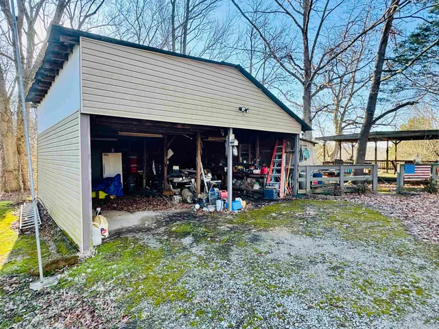 a view of a house with a patio and a yard