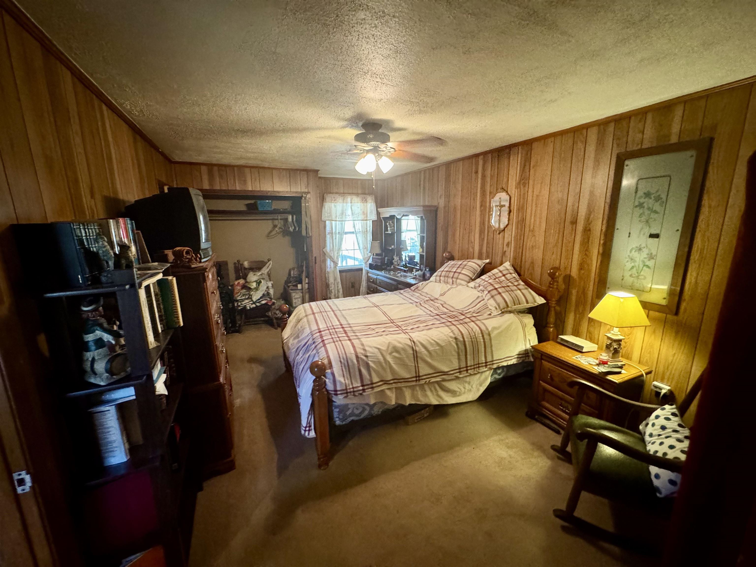 151 Williams Lane Cedar Grove, TN 38321 - Photo 32 of 40 Bedroom with wooden walls, carpet floors, and a textured ceiling