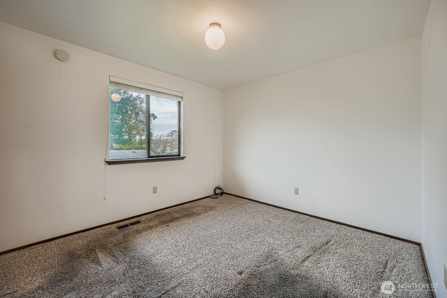 11047 26th Avenue Southwest Seattle, WA 98146 - Photo 11 of 23 an empty room with windows