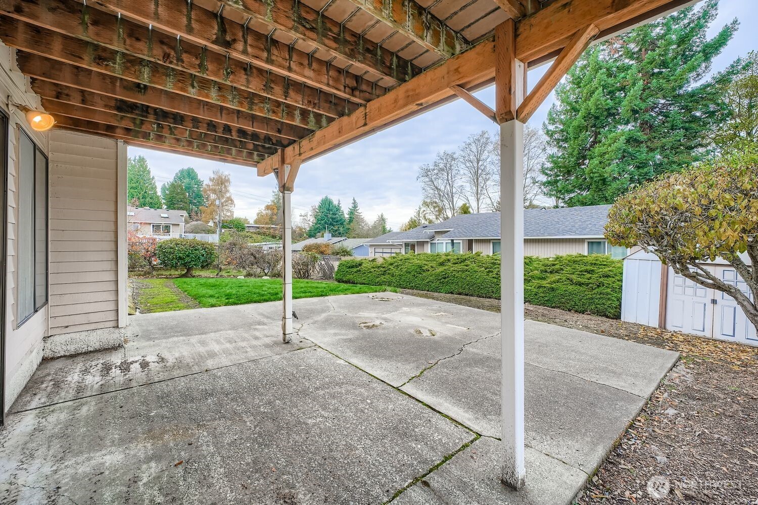 11047 26th Avenue Southwest Seattle, WA 98146 - Photo 16 of 23 a view of a backyard with table and chairs