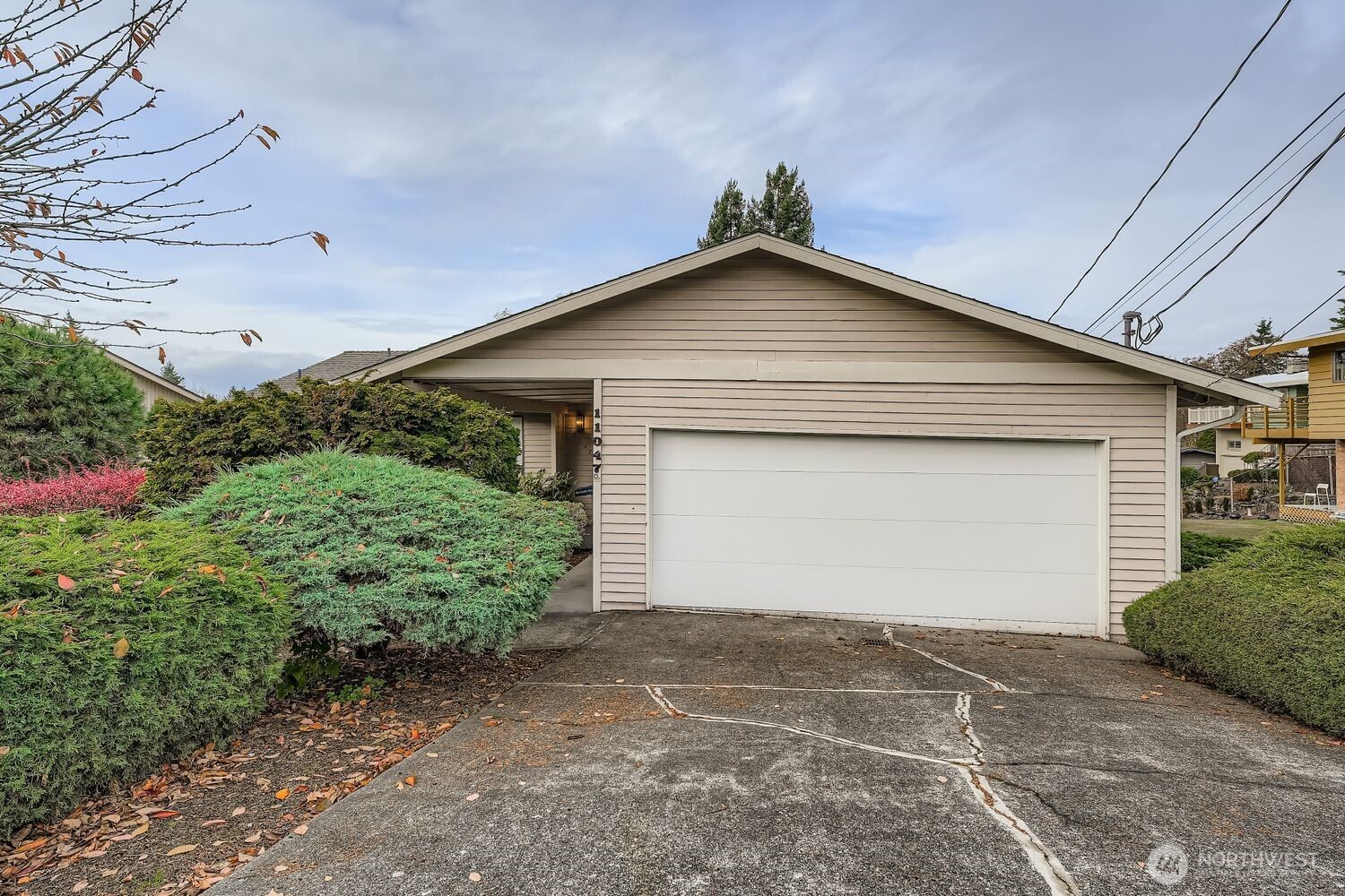 11047 26th Avenue Southwest Seattle, WA 98146 - Photo 2 of 23 a front view of a house with a yard and garage