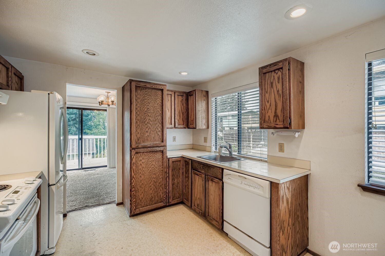 11047 26th Avenue Southwest Seattle, WA 98146 - Photo 4 of 23 a kitchen with a sink cabinets stainless steel appliances and a window