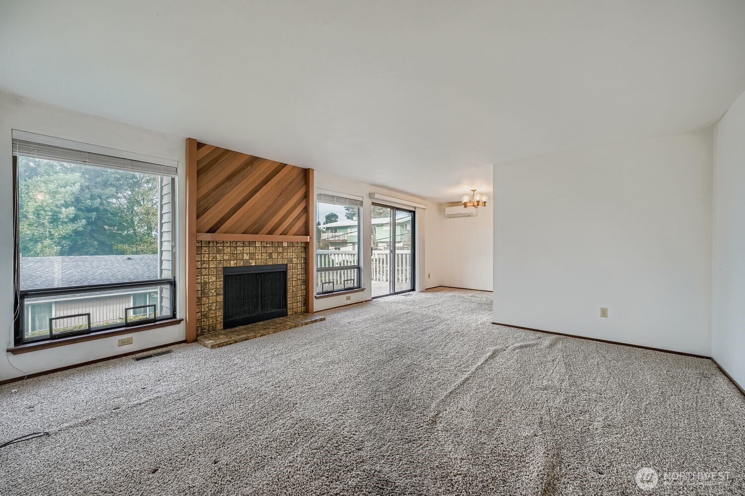 11047 26th Avenue Southwest Seattle, WA 98146 - Photo 7 of 23 a view of an empty room with a fireplace and a window