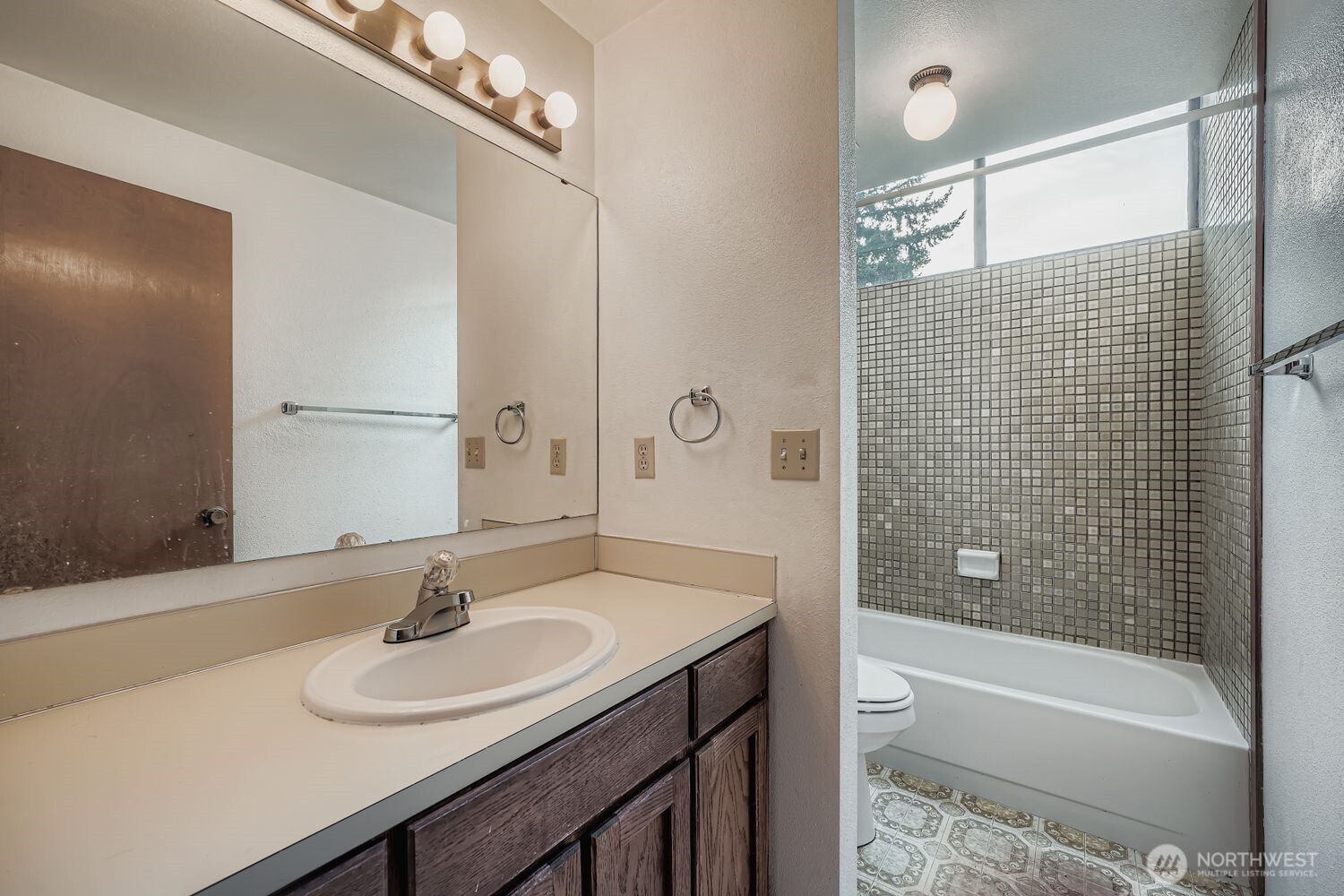 11047 26th Avenue Southwest Seattle, WA 98146 - Photo 8 of 23 a bathroom with a sink double vanity granite tub shower and a mirror
