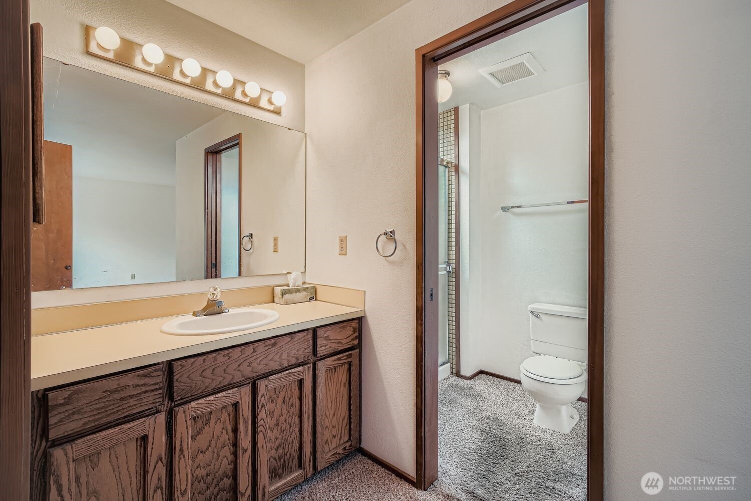11047 26th Avenue Southwest Seattle, WA 98146 - Photo 10 of 23 a bathroom with a sink a toilet and a mirror