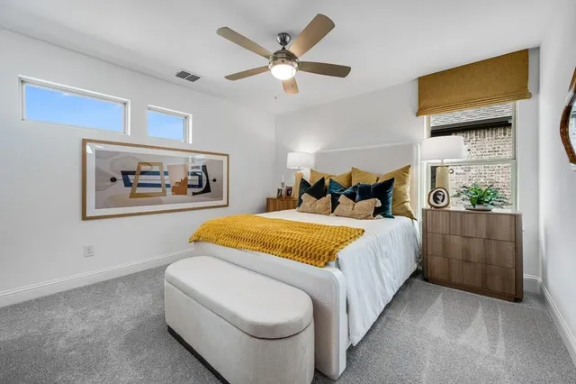 a bedroom with a bed and painting on the wall