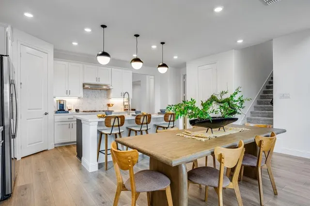 a living room with furniture a fireplace and a mirror