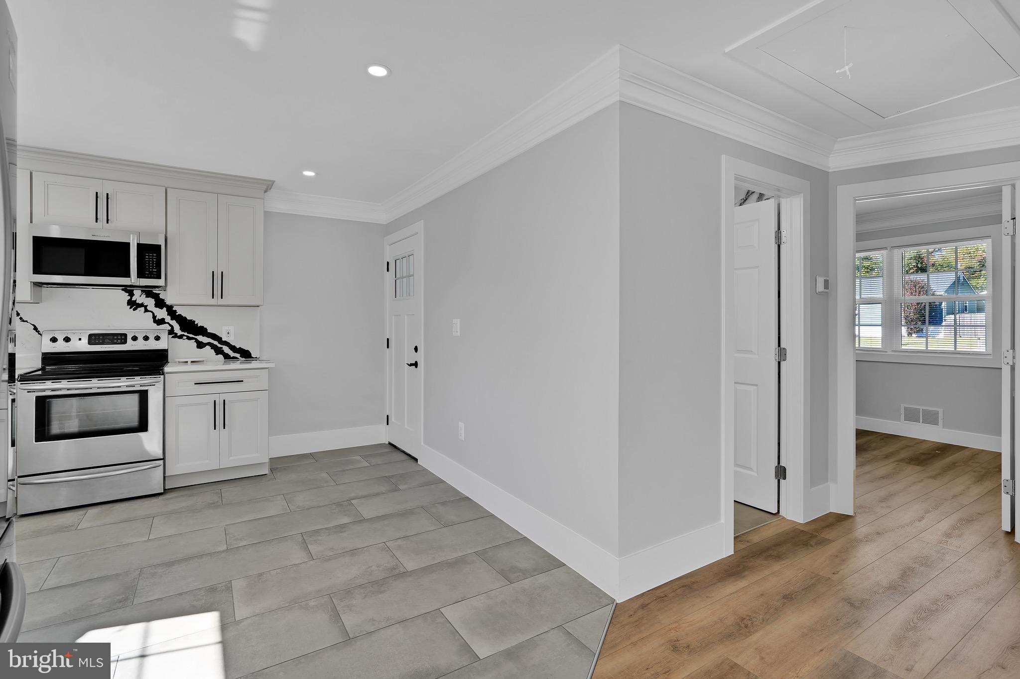 9305 4th Street Lanham, MD 20706 - Photo 14 of 45 a kitchen with a stove and a refrigerator
