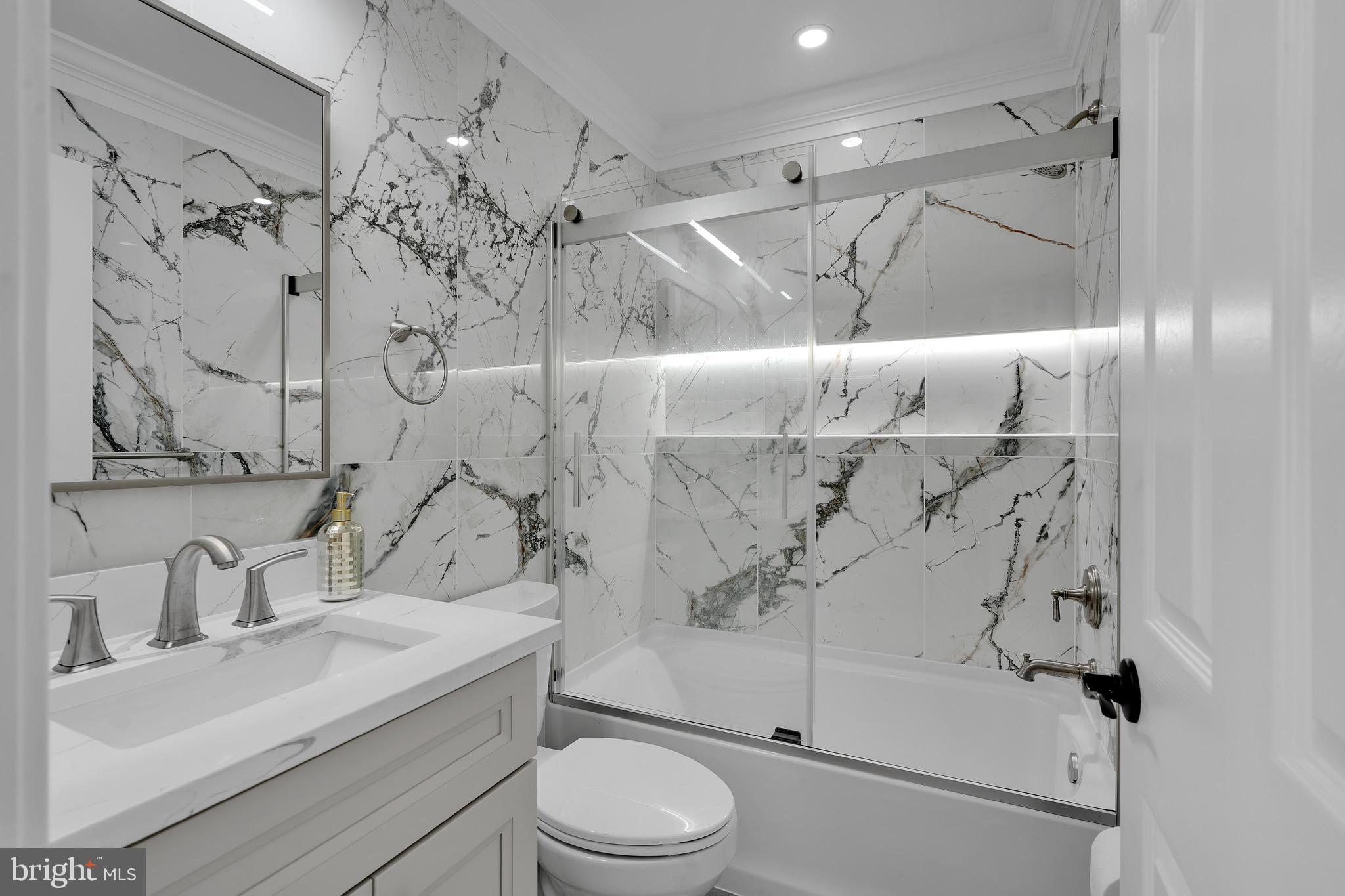 9305 4th Street Lanham, MD 20706 - Photo 16 of 45 a bathroom with a sink toilet and shower