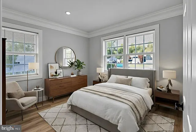 a bedroom with a bed and a dresser next to a window