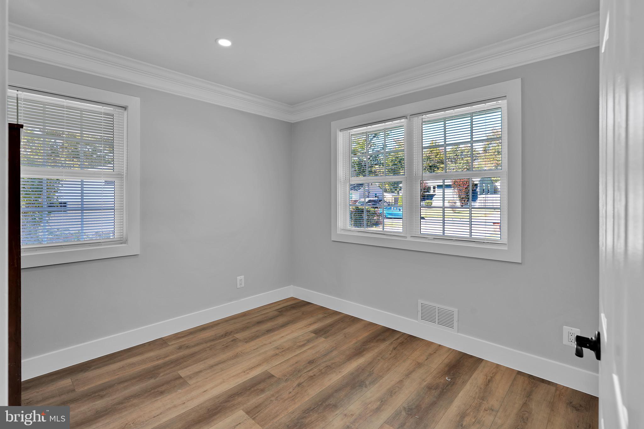 9305 4th Street Lanham, MD 20706 - Photo 18 of 45 a view of empty room with wooden floor and fan