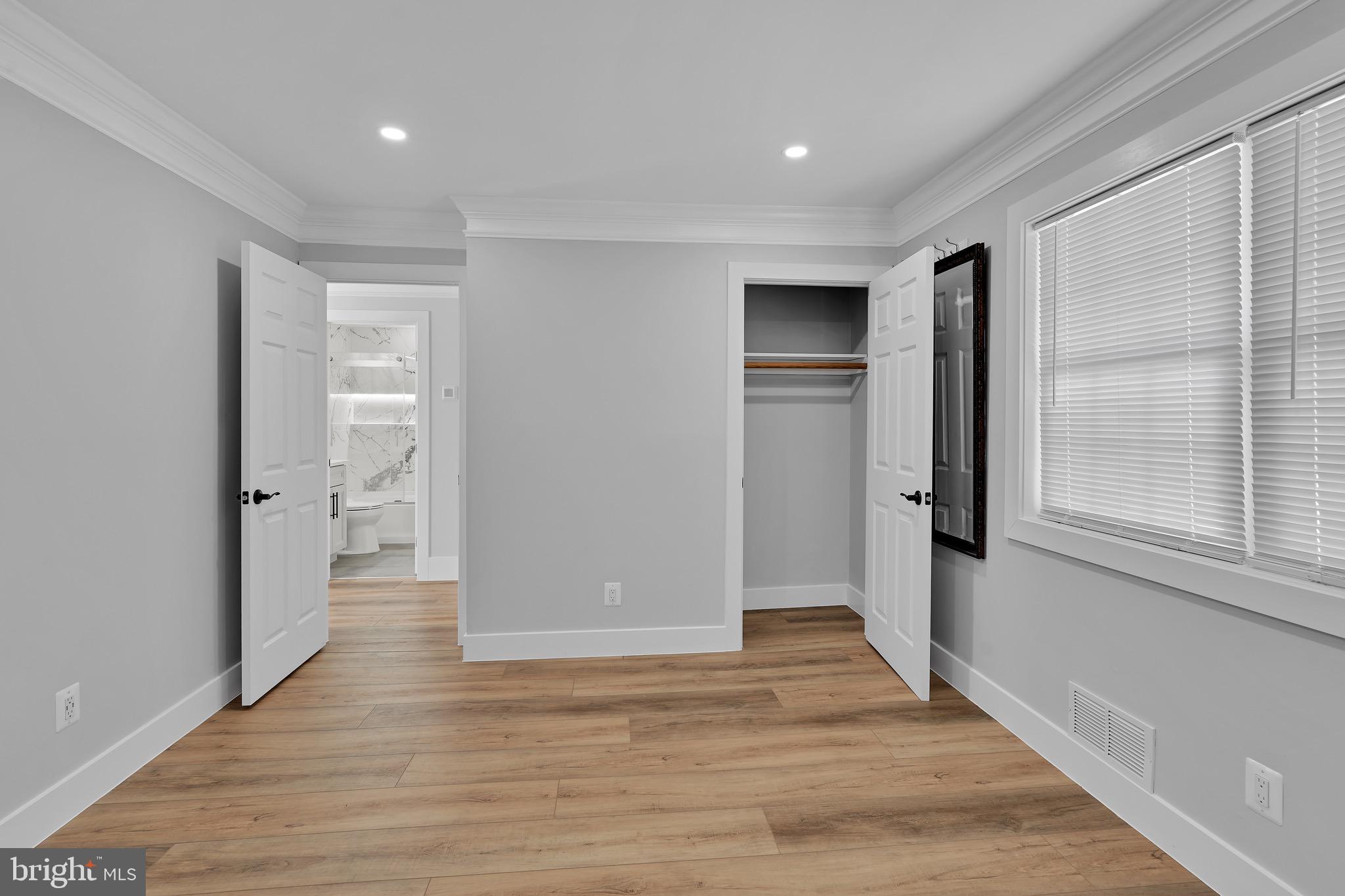 9305 4th Street Lanham, MD 20706 - Photo 21 of 45 a view of an empty room with wooden floor and a window