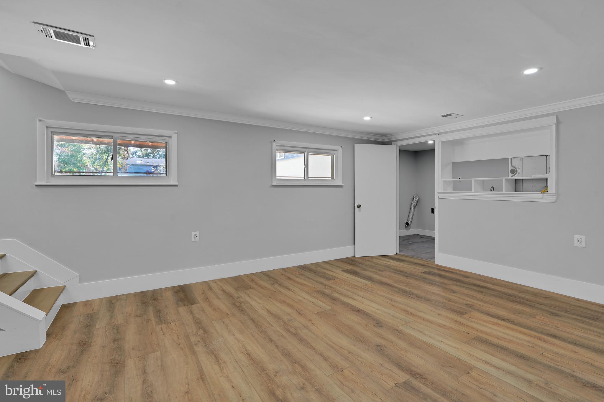 9305 4th Street Lanham, MD 20706 - Photo 25 of 45 a view of an empty room with wooden floor and a window