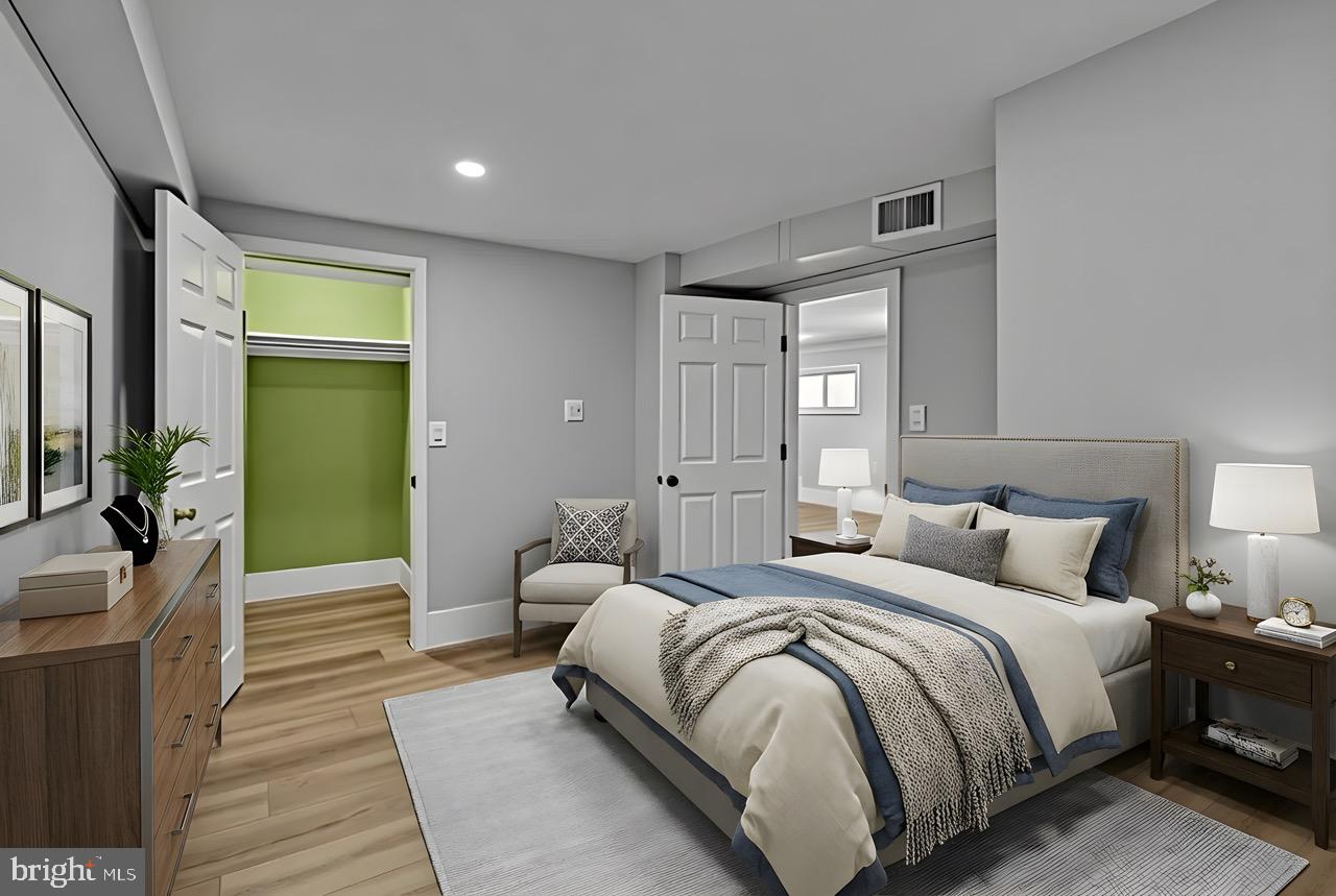 9305 4th Street Lanham, MD 20706 - Photo 27 of 45 a bedroom with a bed and a mirror