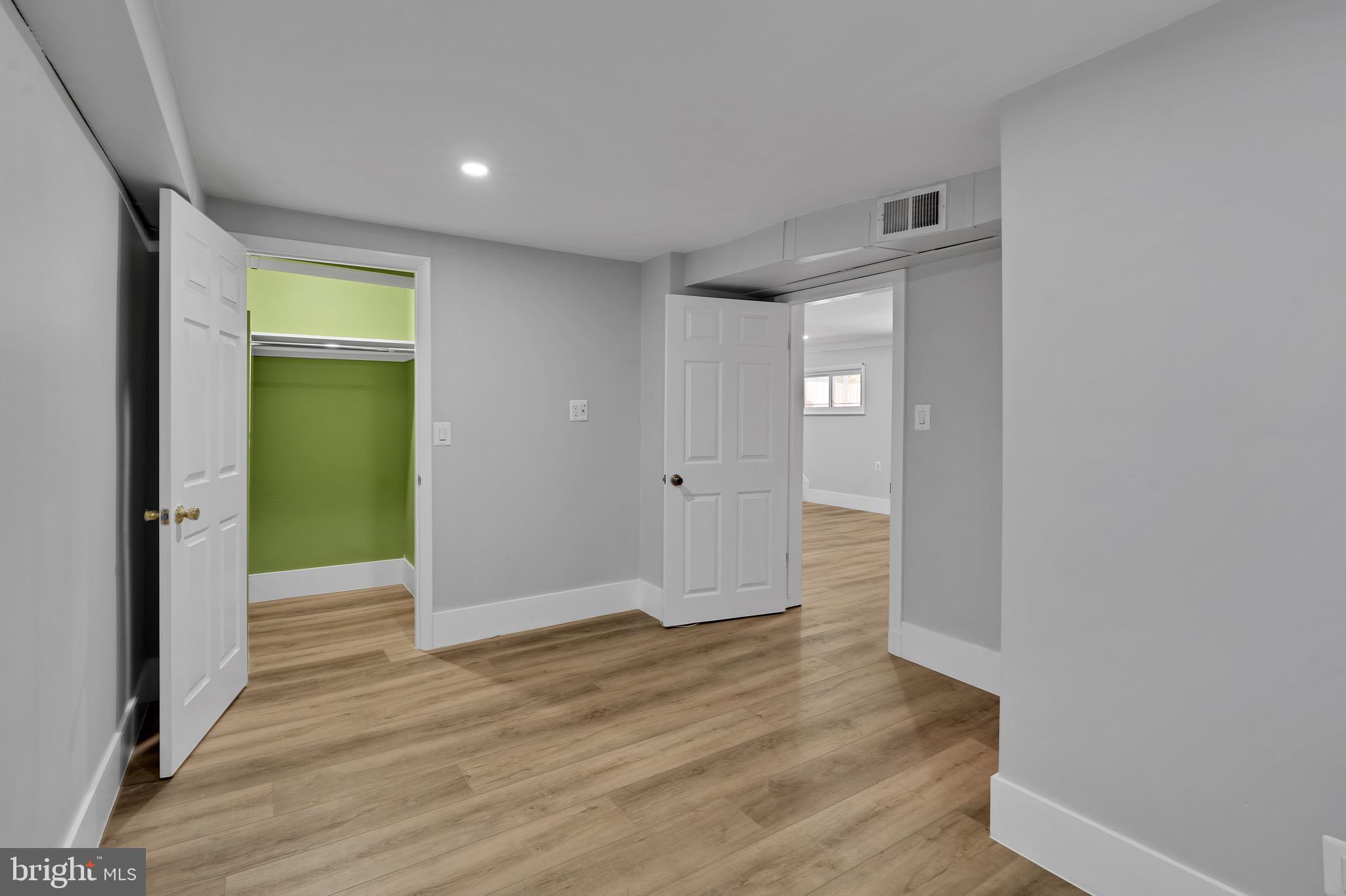 9305 4th Street Lanham, MD 20706 - Photo 28 of 45 a view of an empty room with wooden floor and a window