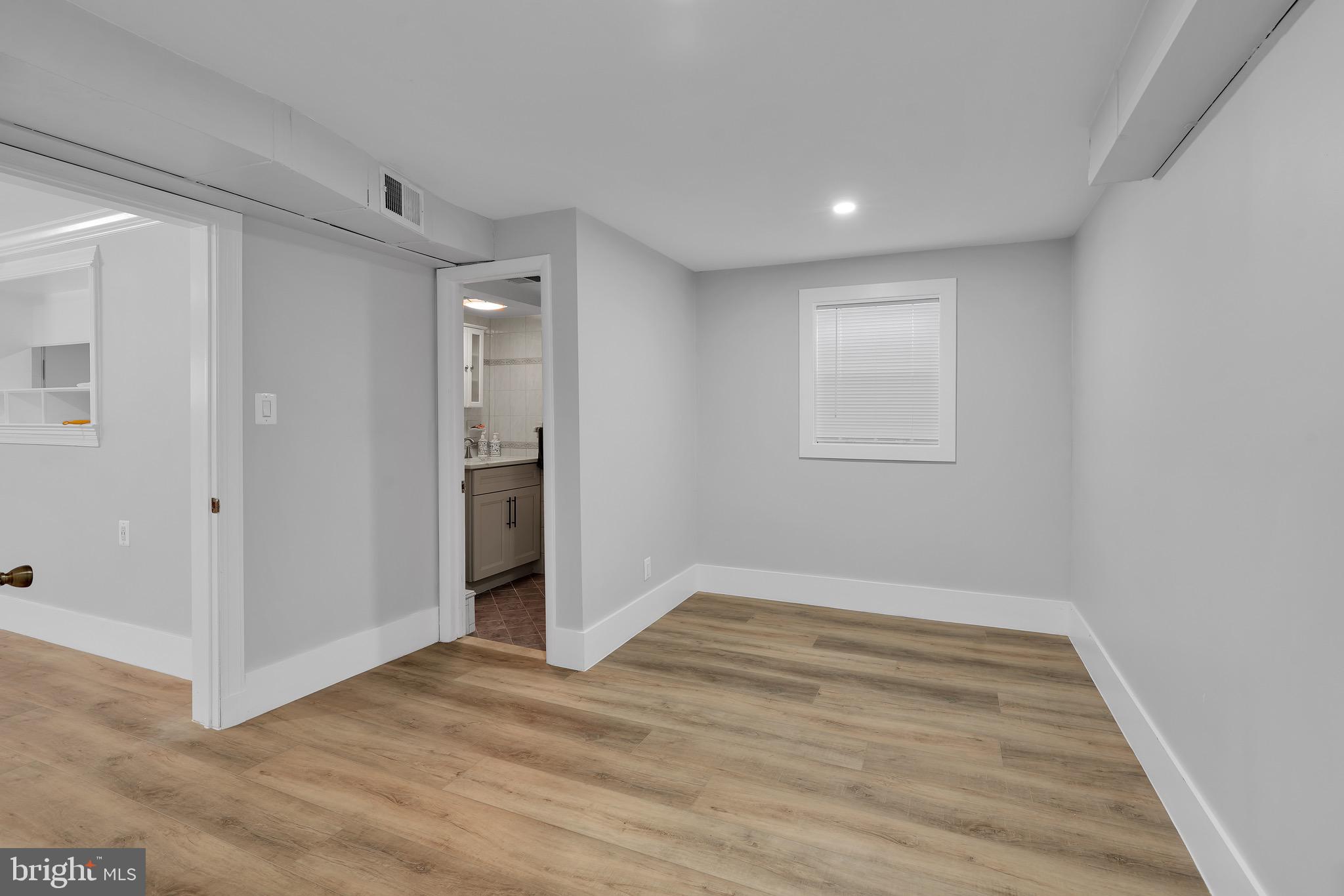 9305 4th Street Lanham, MD 20706 - Photo 29 of 45 a view of an empty room with wooden floor and a window
