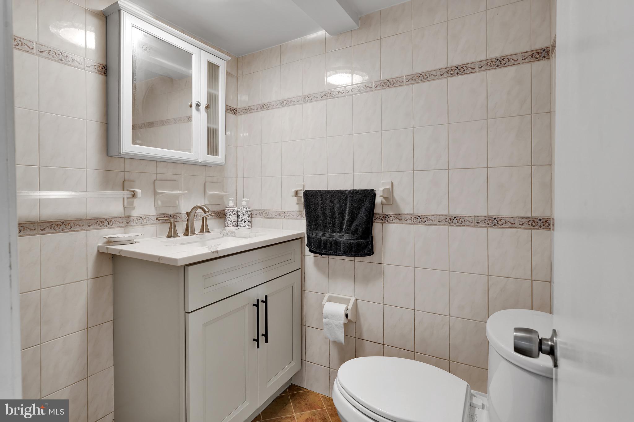 9305 4th Street Lanham, MD 20706 - Photo 30 of 45 a bathroom with a sink toilet and mirror