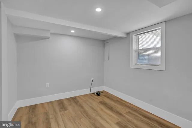 a view of a room with wooden floor and windows