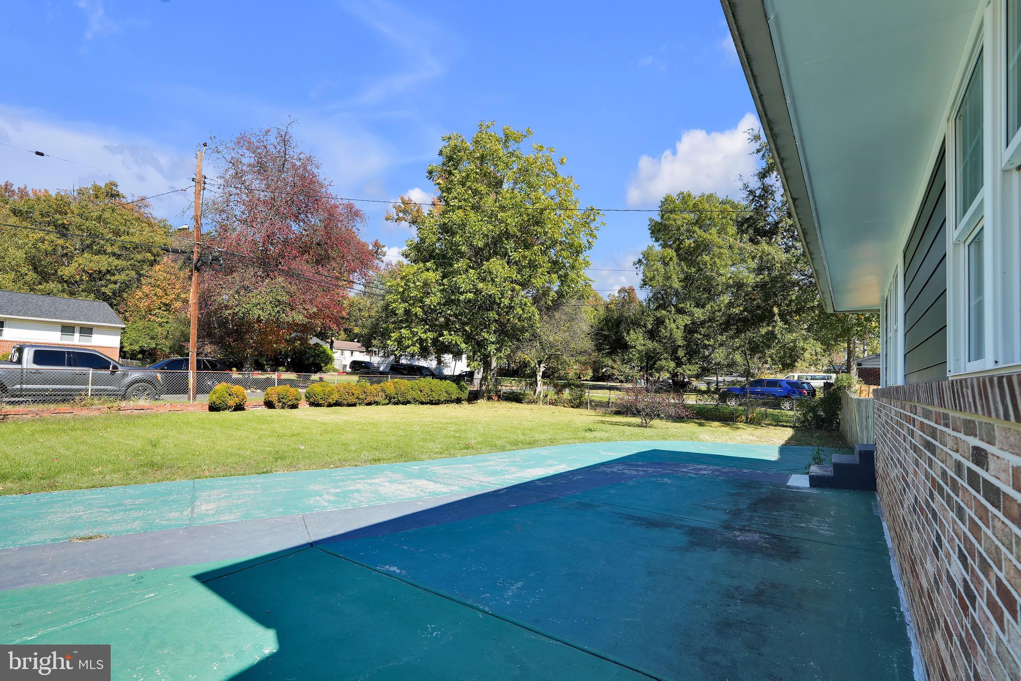 9305 4th Street Lanham, MD 20706 - Photo 4 of 45 a view of yard with swimming pool and trees in the background