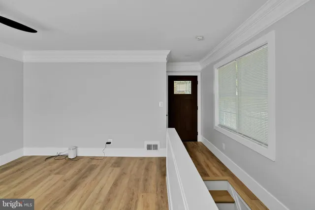 a view of a room with wooden floor and stairs