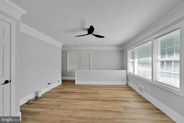 a spacious bedroom with a large bed and a large window