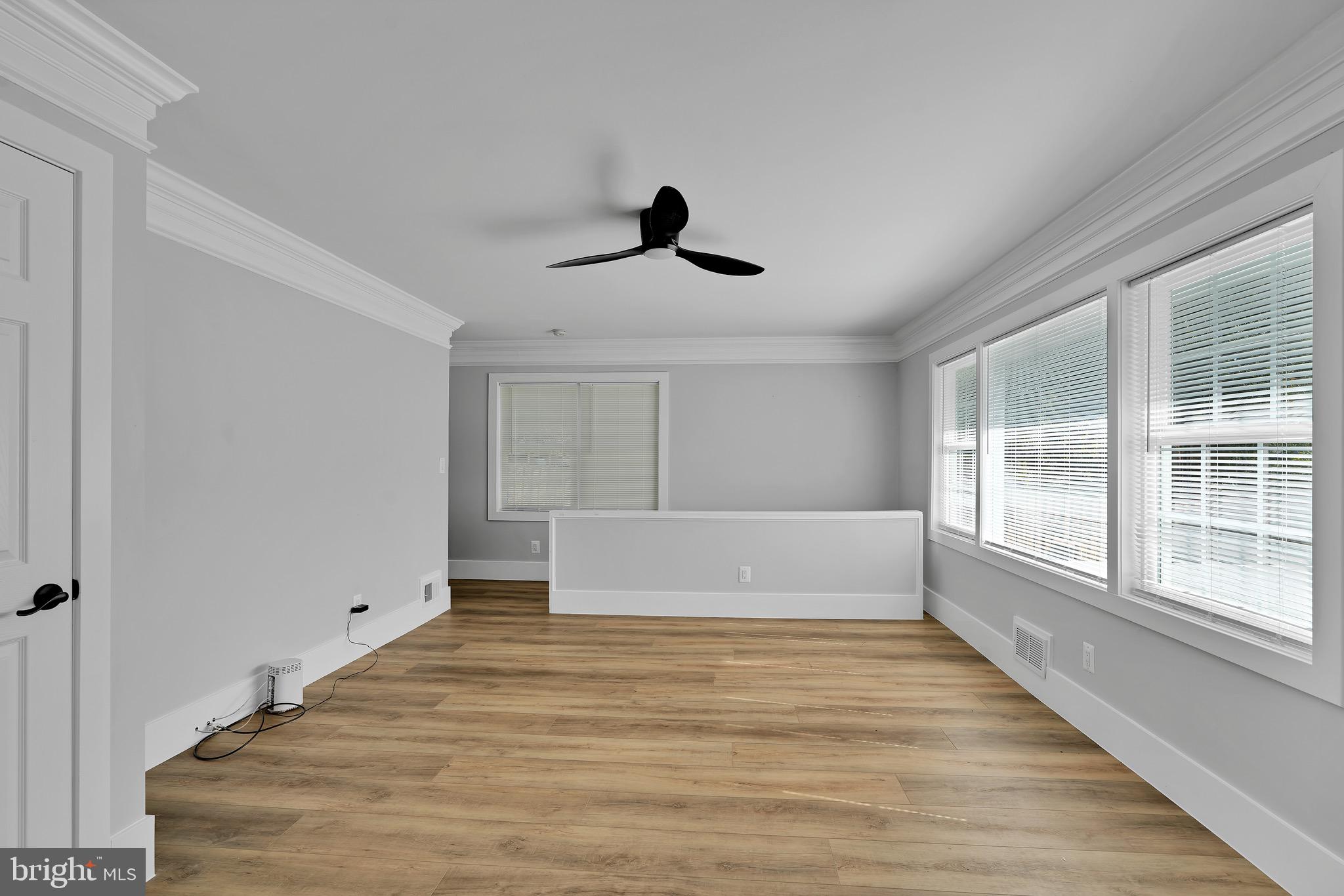 9305 4th Street Lanham, MD 20706 - Photo 7 of 45 a spacious bedroom with a large bed and a large window