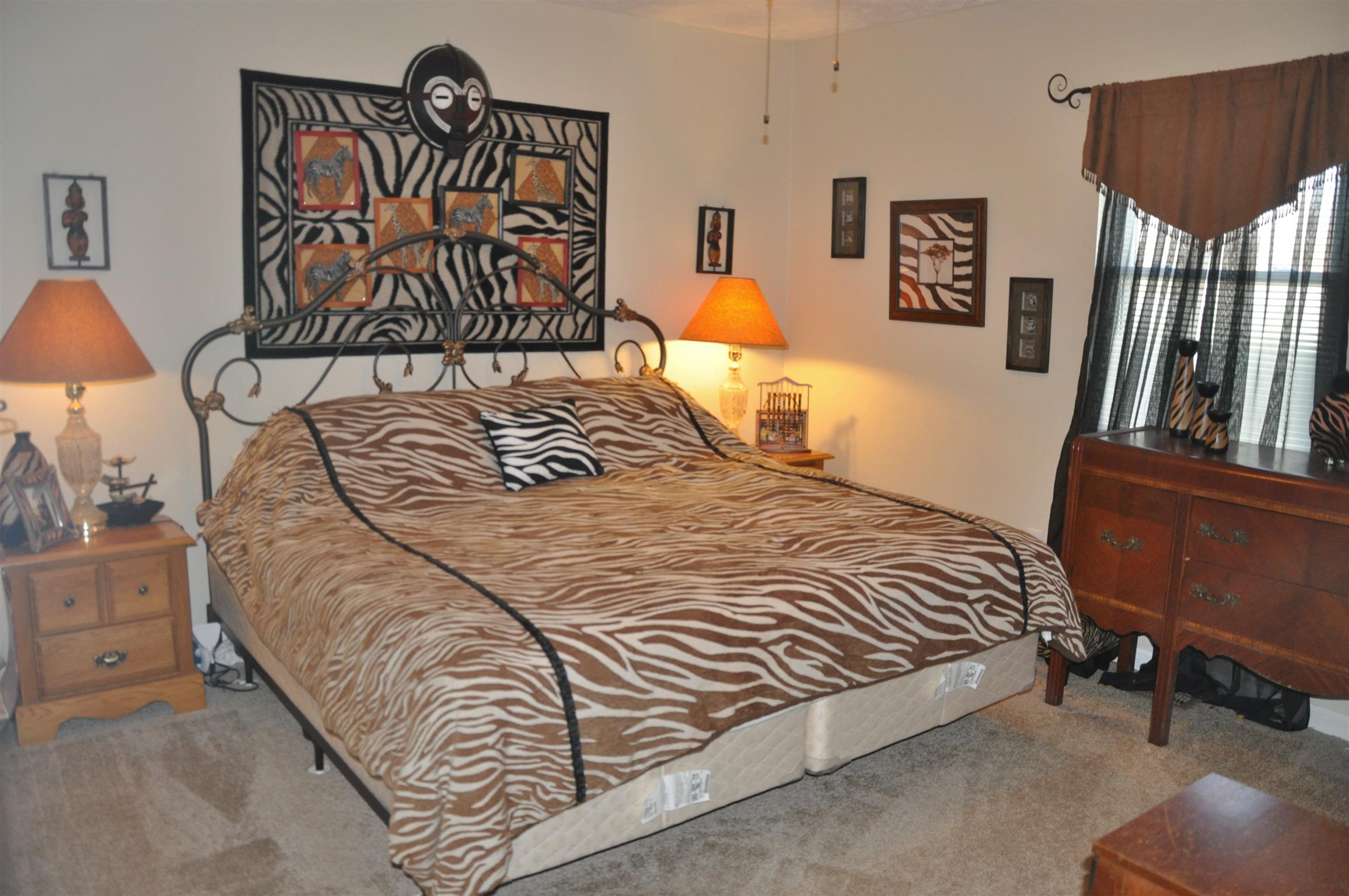 1283 Dale Ridge Road Dowelltown, TN 37059 - Photo 7 of 11 a bedroom with a bed and dresser with mirror