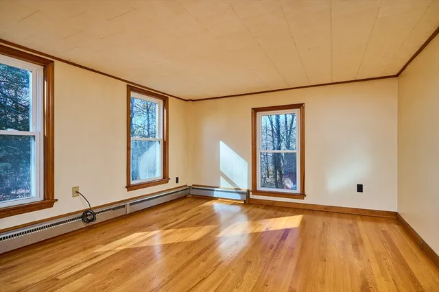 a view of a room with wooden floor and windows
