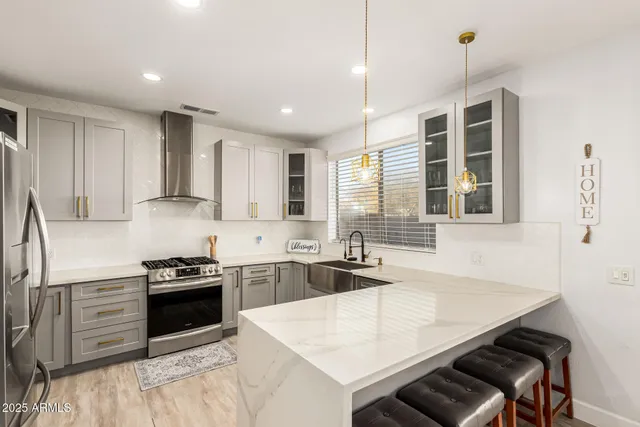 a kitchen that has a stove and a sink