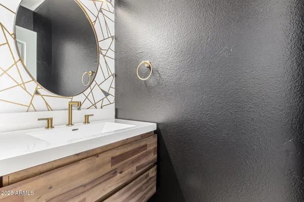 a bathroom with a sink and mirror