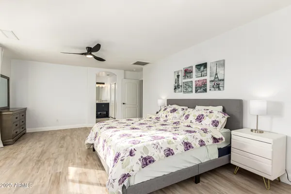 a bedroom with a large bed and a window