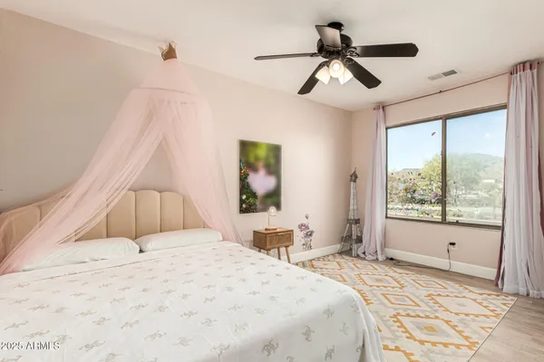 a bedroom with a large bed and a window