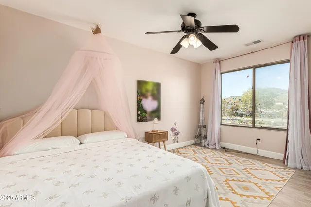 a bedroom with a large bed and a window