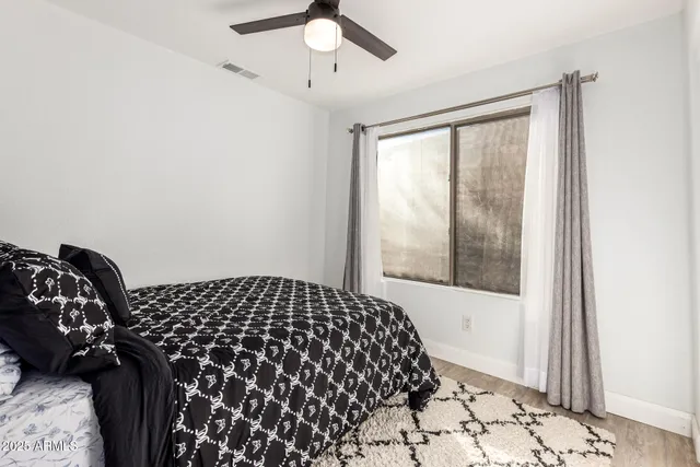 a bedroom with a bed and a window